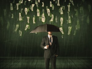 Businessman standing with umbrella in dollar bill rain concept on background